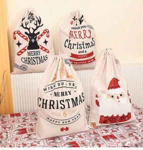 Detail showing four styles of Christmas canvas drawstring gift bags with reindeer and Santa prints