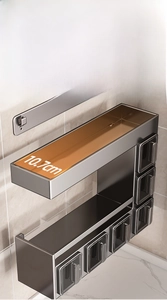 Detail of wall-mounted kitchen spice rack with a 10.7cm widened metal storage shelf