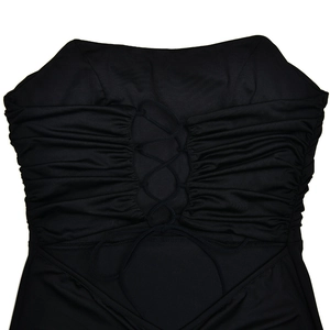 Detail of black backless dress showing side ruched fabric and lace-up corset tie design