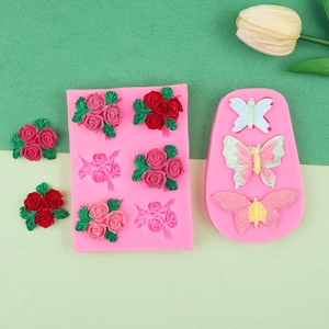 Detail view of pink silicone molds for rose and butterfly DIY resin or clay crafts