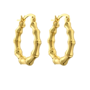 Detail view of golden bamboo style hoop earrings with a polished finish and hinged closure