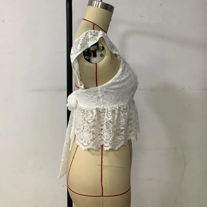 Detail of white lace camisole showing ruffle hem and delicate crochet floral texture