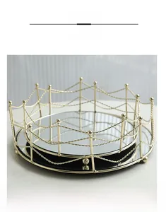 Macro detail of luxury gold geometric metal frame and black mirrored glass tray base