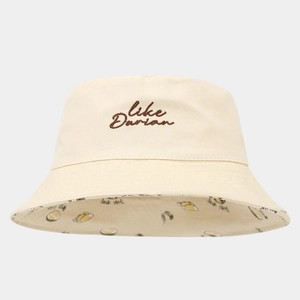Detail of beige cotton bucket hat featuring embroidery and lemon pattern lining
