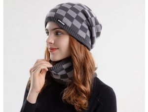 Detail of grey and black checkerboard knit beanie and neck warmer set with soft inner lining