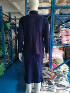 Close-up of deep purple knit sweater and skirt set showing ribbed texture detail