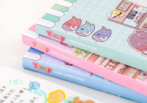 Close-up of pastel cartoon diary covers with magnetic buckles in mint, pink and blue