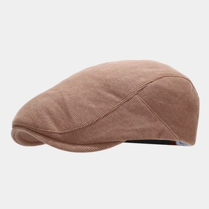 Detailed close-up showing the brown knitted cotton fabric texture of the vintage beret hat