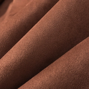 Vue macro de la texture du daim marron avec des plis doux et une finition en microfibre