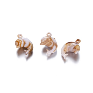 Detailed macro view of acrylic dolphin pendants with brown marble texture for DIY jewelry