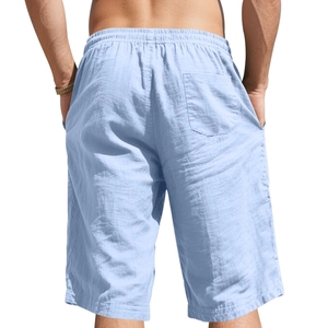 Rear view of men's light blue linen drawstring shorts featuring an elastic waist and back pocket