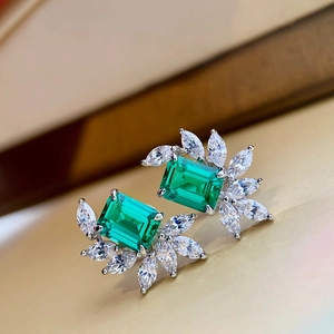 Elegant silver stud earrings featuring emerald-cut green stone and marquise crystals
