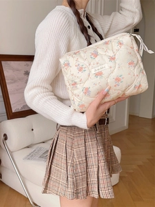 Floral quilted cosmetic bag with soft padding and zipper closure for daily storage