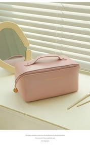 Pink PU leather makeup bag with gold handle and ROSE OF NO MAN'S LAND text detail