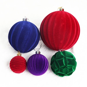 Detailed view of flocked Christmas ornaments with diverse textures on white faux fur