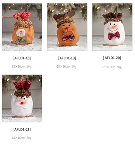 Detail showing plush Christmas drawstring gift bags with Santa and reindeer designs
