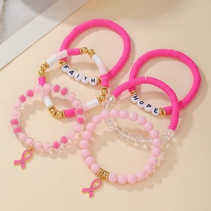Close-up of pink beaded bracelets with Faith and Hope letter beads and ribbon charms