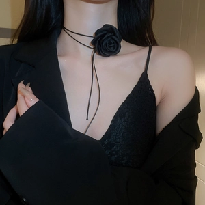 Close-up of handmade black fabric rose choker necklace on model's neck for elegant look