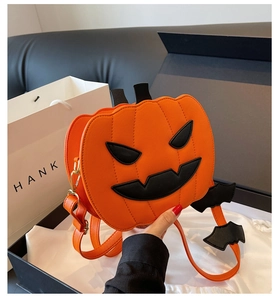 Detail of pumpkin shaped bag with bat wing straps and Jack-o'-lantern face detail