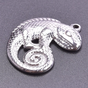 Detailed close-up of a silver lizard pendant with realistic scale textures and top ring