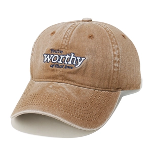 Detailed texture of washed cotton baseball cap with blue embroidered letter lettering