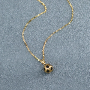 Detailed close-up of a gold-plated stainless steel football pendant with O-chain link