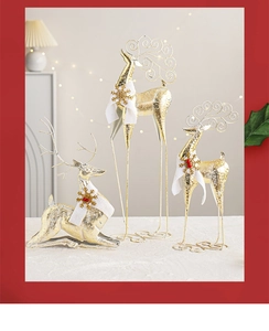 Three gold Christmas reindeer figurines with festive scarves for holiday table decor
