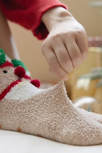 Close-up of thick coral fleece Christmas socks with non-slip silicone grip and soft stretch