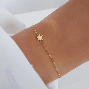 Minimalist S925 sterling silver star bracelet with gold plating on female wrist