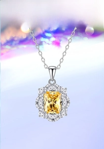 Detail view of floral S925 silver necklace with radiant cut yellow gemstone and diamonds