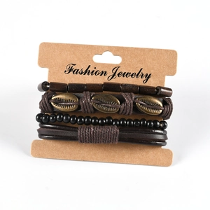 Detail view of retro braided leather bracelet set with wooden beads and shell charms
