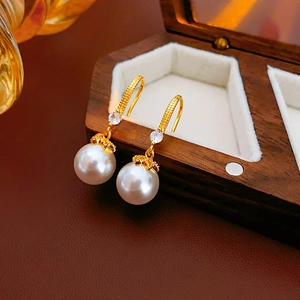 Detailed 45-degree view of elegant 14K gold plated pearl hook earrings with zircon