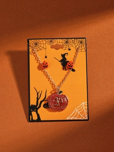 Detail of Halloween necklace with red rhinestone pumpkin pendant and golden chain