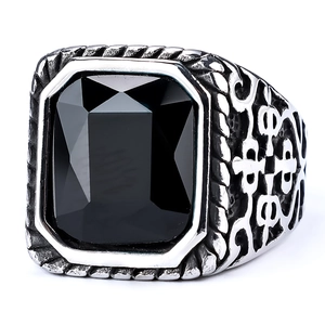 Vintage stainless steel ring with a large rectangular black gemstone and ornate engraving