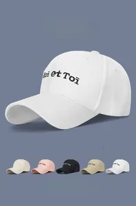 Close-up of cotton baseball cap with Moi et Toi embroidery and multi-color options