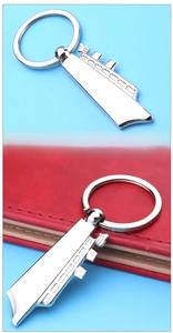 Polished silver cruise ship metal keychain with a sleek mirror finish on red leather
