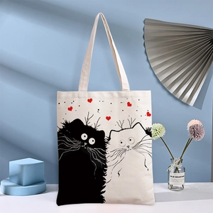 White canvas tote bag featuring cute cartoon cats and red heart print with wide handles