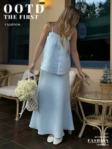 Detail of light blue two-piece cotton set with spaghetti strap top and long fishtail skirt