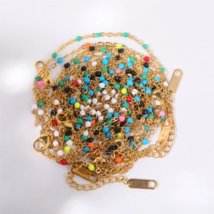 Detail of colorful enamel bead necklace with gold K18 engraved tag and clasp