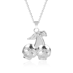 Macro shot of silver skull cherry pendant made of polished stainless steel on white