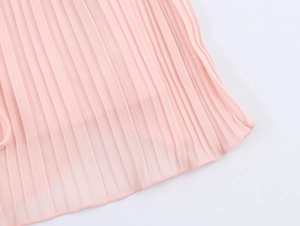 Detail shot of pleated pink chiffon fabric showing texture and overlock hem edge