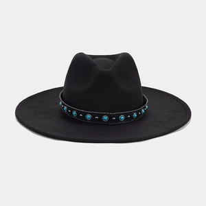 Detail of black wide brim fedora hat featuring turquoise beads and silver buckle accents