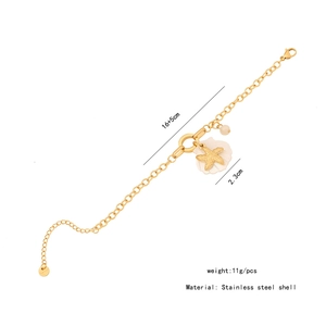 Detailed view of starfish and shell charms on a gold stainless steel bracelet with specs