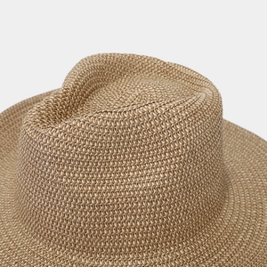 Close-up of tight woven texture and classic indented crown on a straw Panama hat