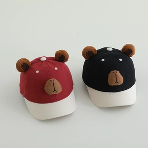 Close-up of adorable plush capybara ears and face embroidery on kids baseball caps