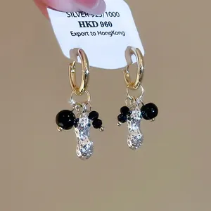 Macro shot of S925 silver peanut earring with crystal inlay and black agate beads