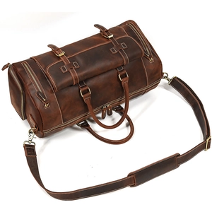 Detail view of vintage dark brown crazy horse leather duffel bag with shoulder strap