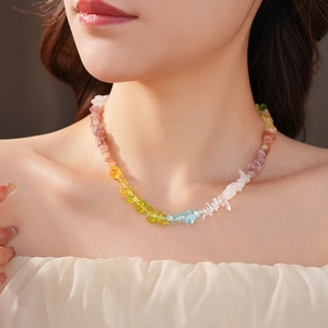 Detail of colorful rainbow natural stone beaded necklace on model for vacation style
