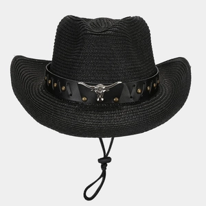 Detail of western straw cowboy hat featuring black leather band and silver bull head emblem