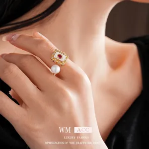 Gold plated square vintage ring with red gemstone and large white pearl detail